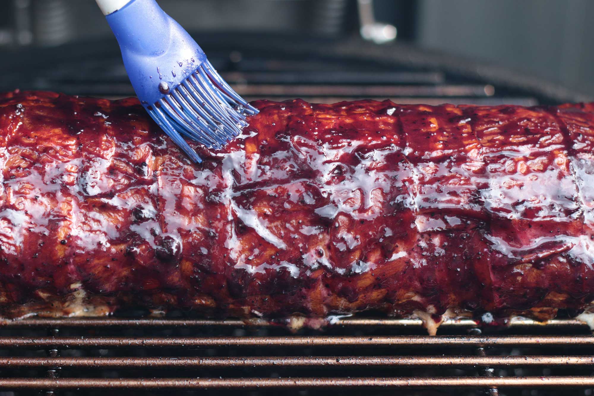 Die Bacon Bomb wird mit BBQ Sauce glasiert